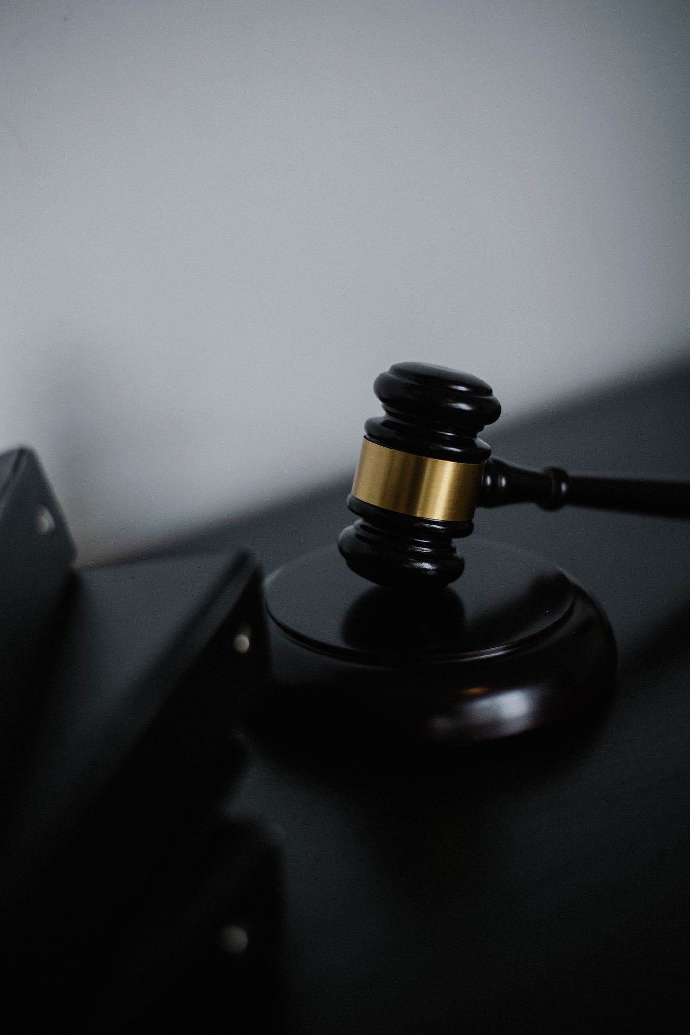 A black and gold gavel on a dark surface